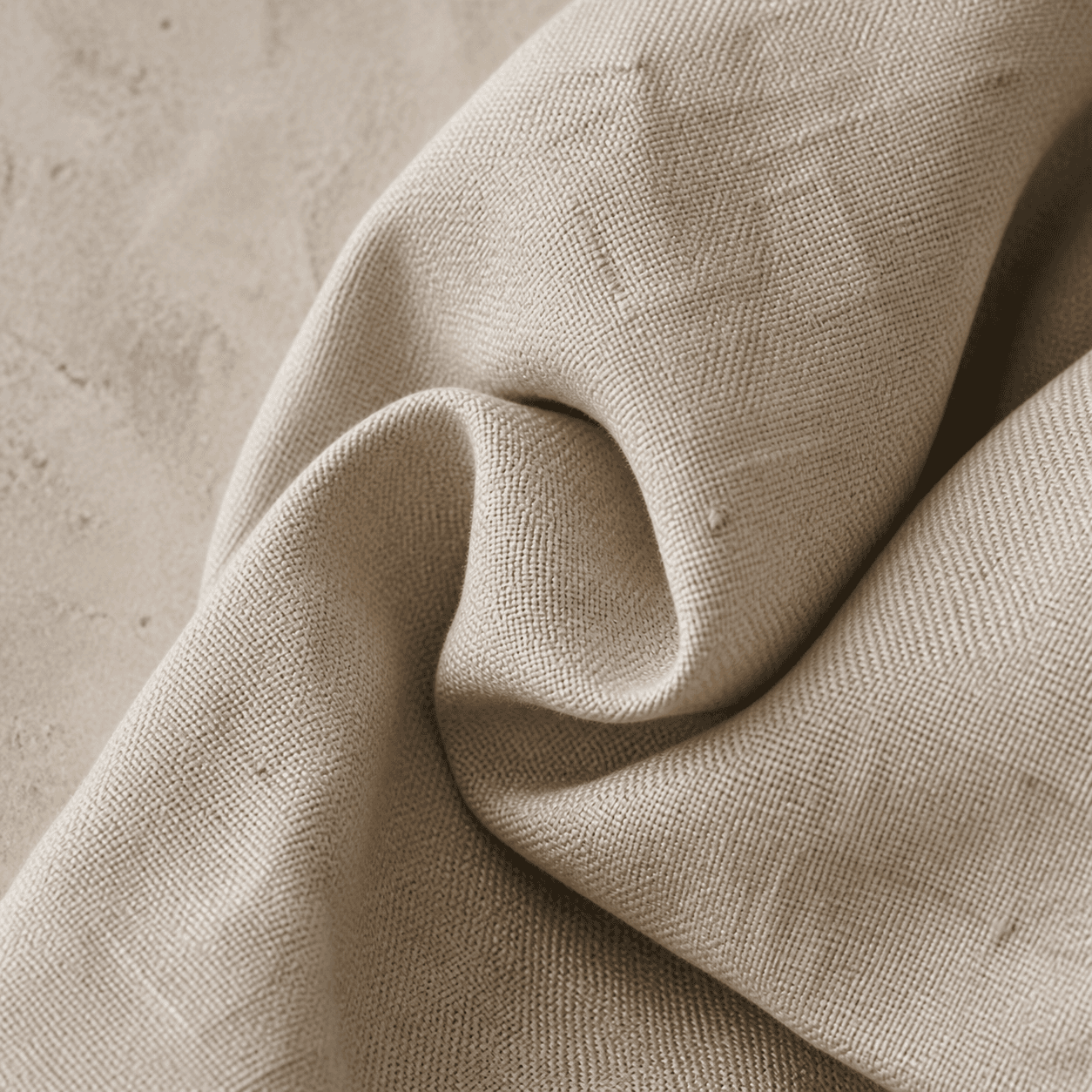 Macro view of a stone cotton-linen blend combining an even weave with subtle slubs