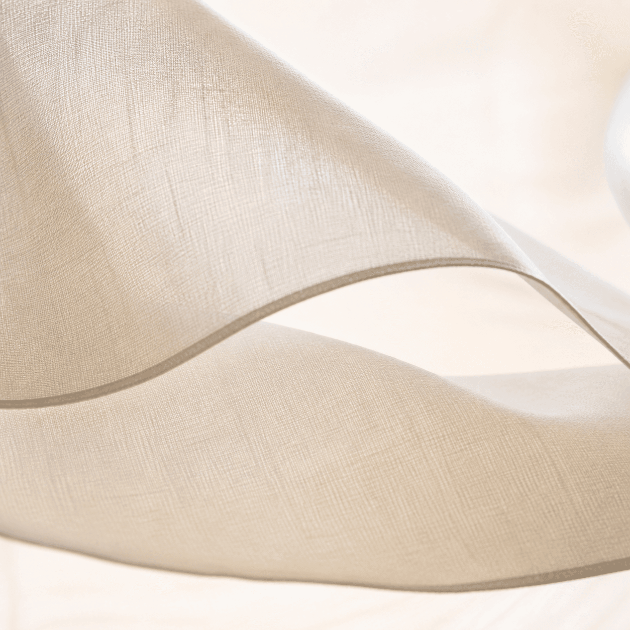 Macro view of two luminous semi-opaque layers of fine chalk cotton voile