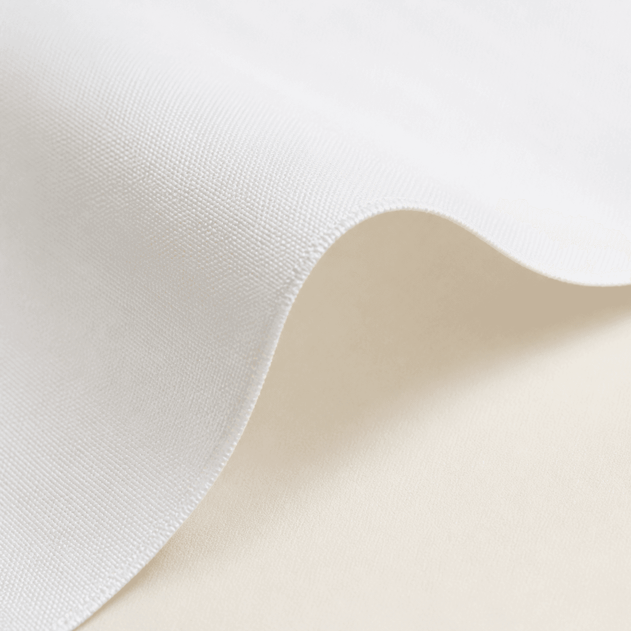 Macro view of chalk cotton poplin folded into a precise wave