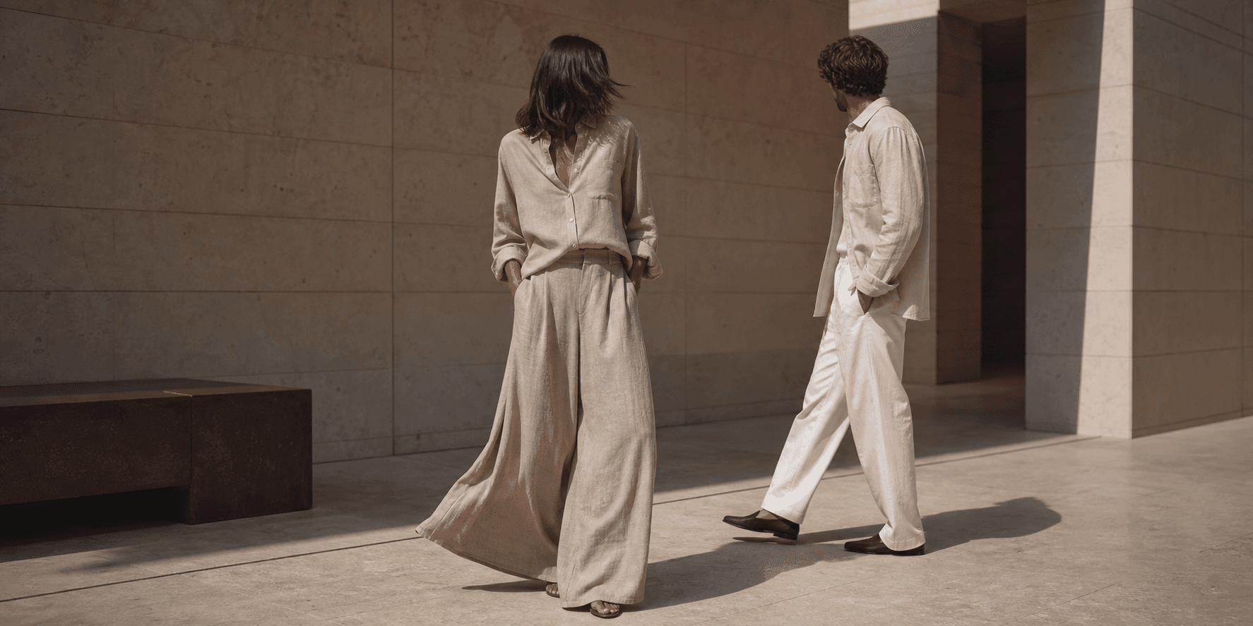 Man wearing a chalk linen shirt and relaxed trousers in warm stone architecture